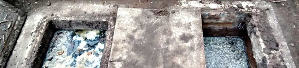 Open septic tank showing two chambers and concrete cover
