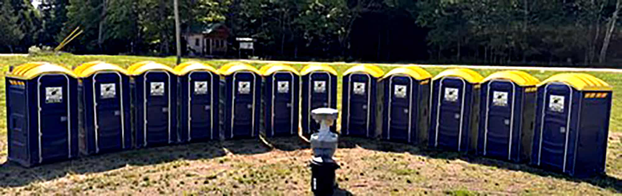 Row of portable toilets in a semi-circle outdoors