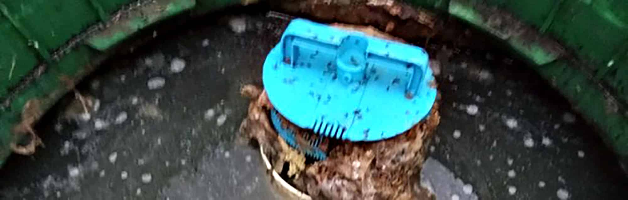 Septic tank with blue lid and visible waste material