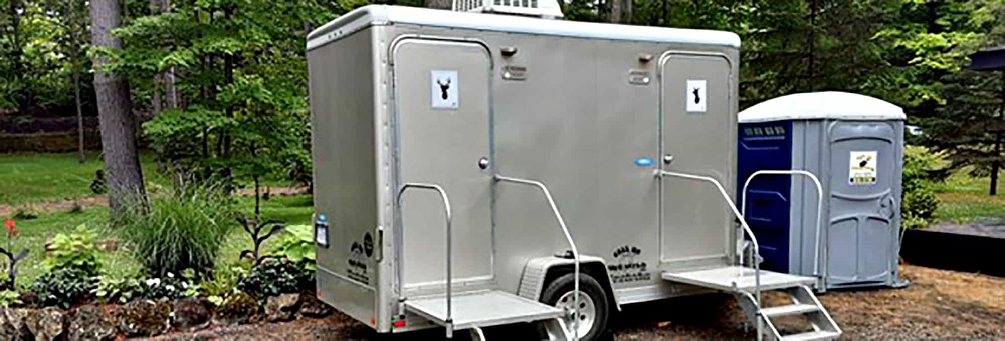 Portable luxury restroom trailer in a lush park setting