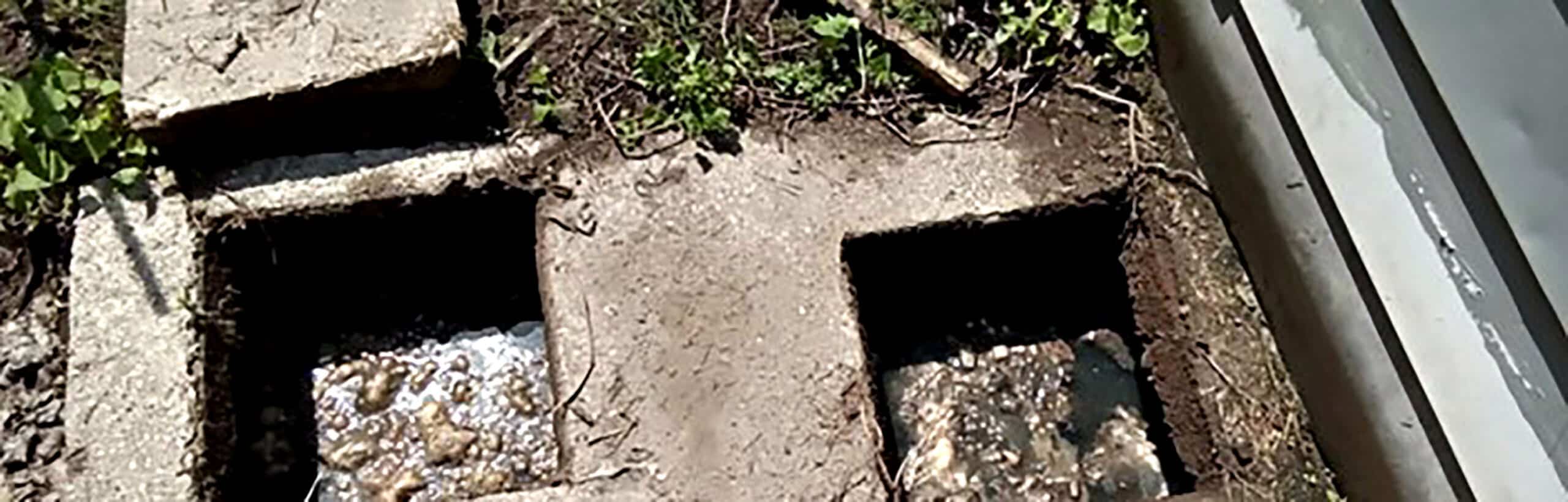 Open septic tank with two caps showing interior