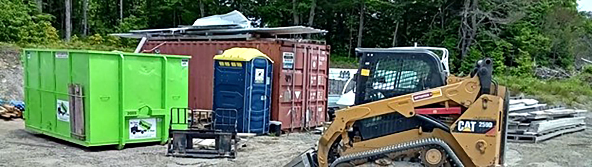Construction site with storage containers and portable toilet