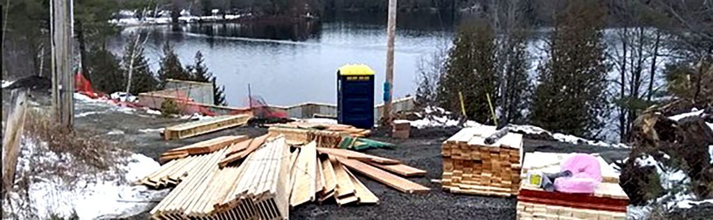 Construction materials near a frozen lake in winter setting